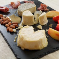 An assortment of local cheeses, fruit and nuts to enjoy 