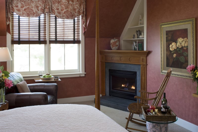 Bed and Breakfast. Malena's Tango queen suite offers a sitting area near a gas fireplace with window views of the gardens
