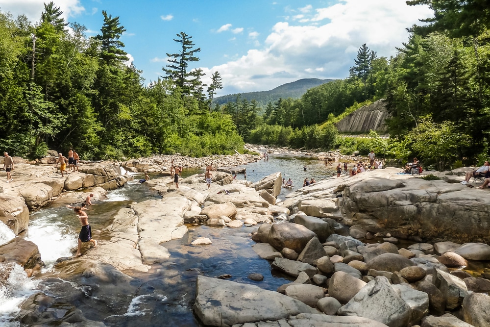People playing in the water during warm weather at the Quechee Gorge and Quechee State Park